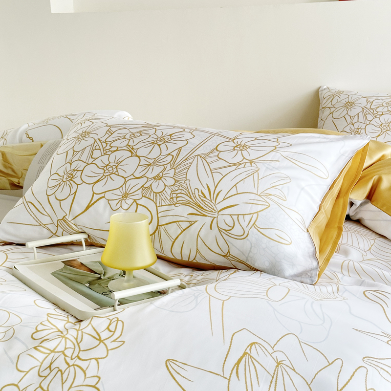  Two pillowcases feature floral patterns outlined in lines