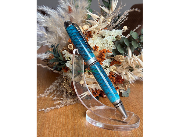 Pine cone set in blue and white epoxy with cigar kit