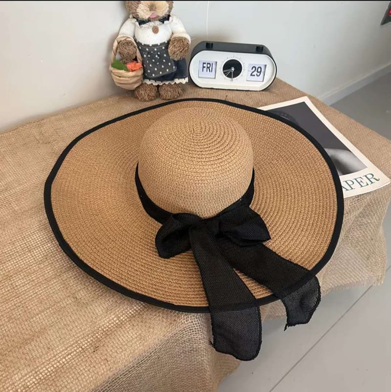 Natural straw wide brim sun hat with black trim and chiffon bow for women beach vacation