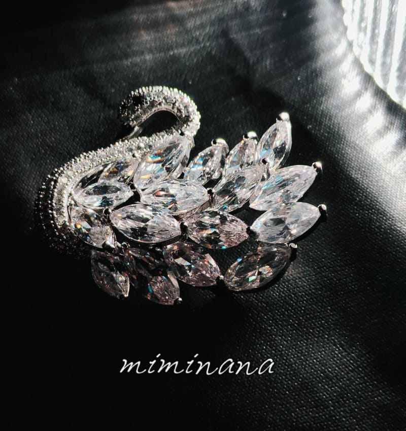 Sparkling marquise cut crystal swan pin black fabric backdrop