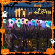 Colorful solar eyeball garden stakes with flexible stems for outdoor Halloween yard decor.