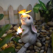 Solar rabbit garden statue with glowing butterfly on nose and LED flowers, IP65 waterproof resin bunny yard decor.