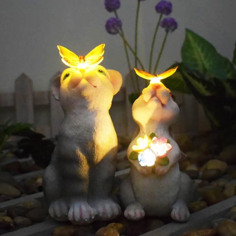 Solar rabbit garden statue with glowing butterfly on nose and LED flowers, IP65 waterproof resin bunny yard decor.
