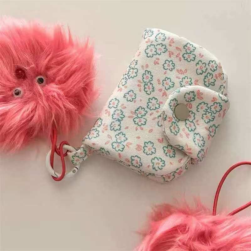 Sweet pink canvas pouch with bow pattern and button closure. Compact 9.5x10cm lightweight 45g accessory pouch for organizing coins and small essentials.