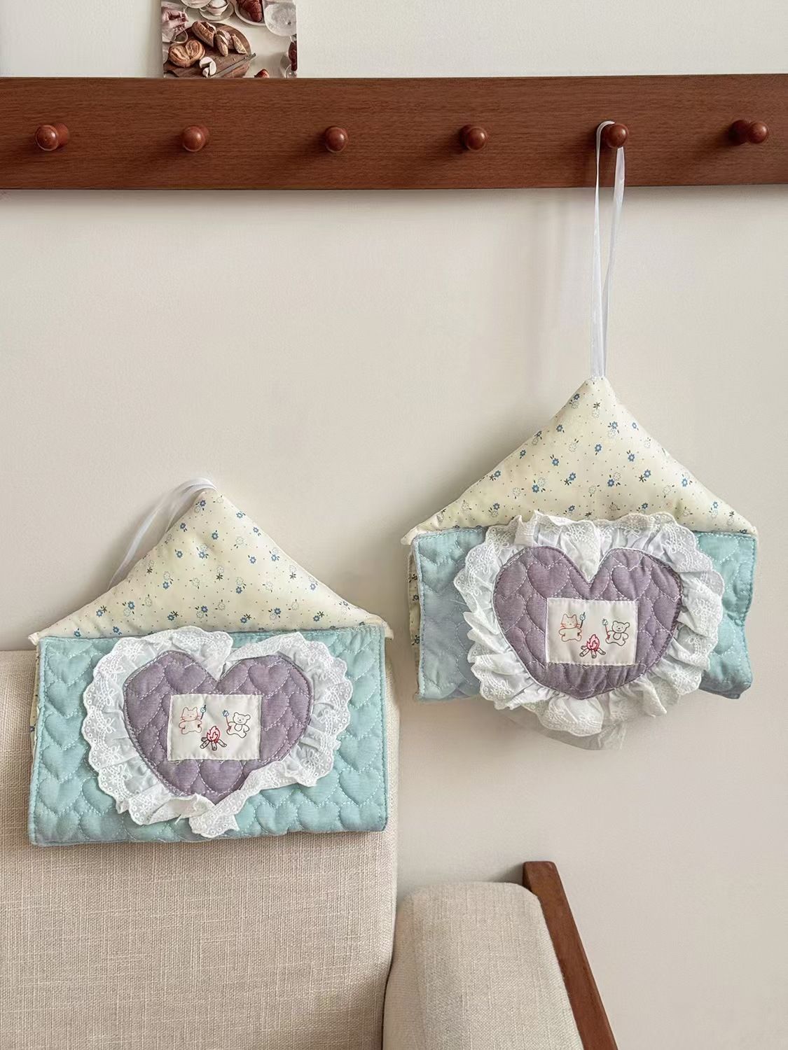 Coquette hanging tissue box cover on wall, space-saving fabric tissue holder for small dorm rooms and bedrooms.