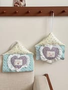 Coquette hanging tissue box cover on wall, space-saving fabric tissue holder for small dorm rooms and bedrooms.