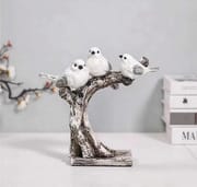 Three white birds perched on a textured tree sculpture