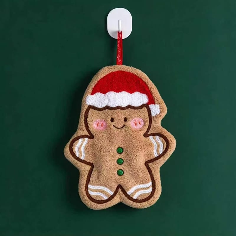 Gingerbread person shaped Christmas hanging towel wearing a Santa hat